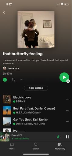 an iphone screen showing the music player on it's playlist, and two people hugging each other