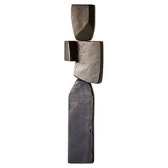 an abstract sculpture made out of rocks on a white background