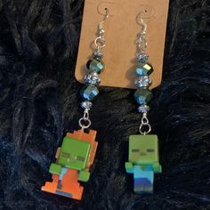 New/Handmade, Minecraft Zombie Earrings. Miniature Minecraft Zombie Figures, Plastic Beads And Surgical Steel Hooks. Made From Officially Licensed Minecraft Miniature Toys. Measures Approx 3 3/4 Inches Long Weighs Approx 0.7 Ounces Handmade Orange Dangle Jewelry, Orange Earring Jewelry Gift, Handmade Orange Beaded Earrings As Gift, Minecraft Earrings, Minecraft Jewelry, Zombie Earrings, Minecraft Zombie, Disney Earrings, Chicos Jewelry