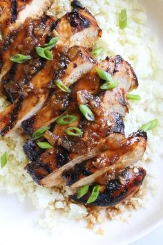 grilled pork chops and rice on a white plate