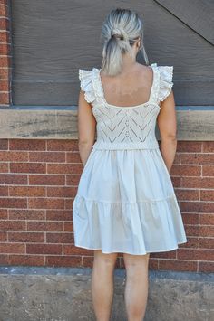 The Ruffled Sleeves Sweater Top Combo Dress in a natural color is a beautifully crafted garment that merges the coziness of a sweater with the elegance of a dress. This piece is designed to offer a seamless look that combines two distinct styles into one harmonious outfit, making it a unique addition to any wardrobe. The top portion of the dress features a sweater-like fabric that is soft and comforting, perfect for cooler days. It is distinguished by its eye-catching ruffled sleeves which add a Beige Cotton Mini Dress With Lace Trim, Beige Cotton Mini Dress With Ruffle Hem, Casual Cream Mini Dress With Ruffles, Cottagecore Mini Dress With Ruffles For Daywear, Off White Ruffled Casual Mini Dress, Casual Off White Mini Dress With Ruffles, Off White Cotton Mini Dress With Ruffles, Casual Off-white Ruffled Mini Dress, Casual Neutral Dress With Ruffles