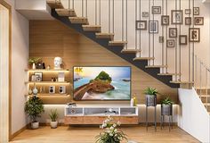 a living room filled with furniture and a flat screen tv sitting on top of a wooden table