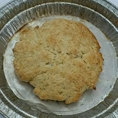 an uncooked biscuit sitting on top of a metal pan