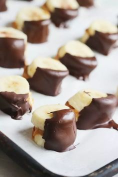 chocolate covered bananas are on a baking sheet