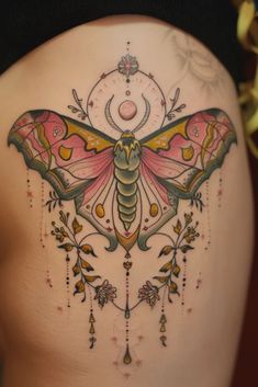 the back of a woman's stomach with a colorful butterfly tattoo on her belly