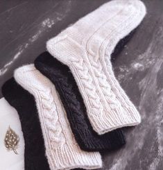 three pairs of white and black knitted socks