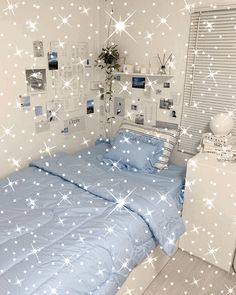 a bed room with a neatly made bed and white stars on the wall above it