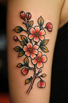 a woman's arm with flowers and leaves on it