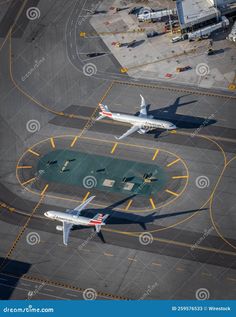 an aerial view of two airplanes on the tarmac