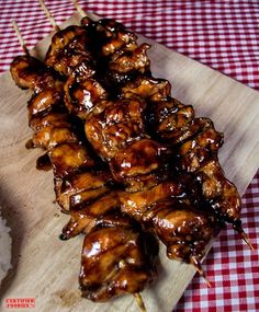 chicken skewers on a cutting board with rice