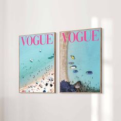 two magazine covers on the wall next to each other in a room with white walls