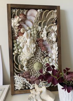 an art work made out of seashells and flowers