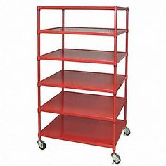 a red shelf with four shelves on wheels