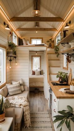 the interior of a tiny house with wood flooring and white walls, wooden ceiling