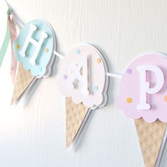 an ice cream cone banner with the letters p and o on it, hanging from a wall