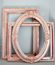 three antique frames are stacked on top of each other, with one empty frame in the middle