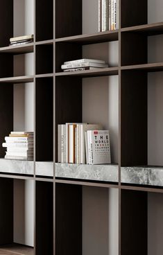 a book shelf with books on top of it and a remote control in front of it