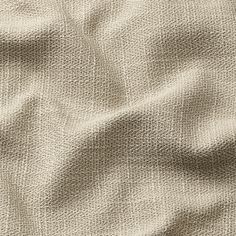 an up close shot of the texture of a linen material, which is light brown