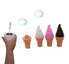 a hand holding an ice cream cone in front of five cones with bubbles coming out of them