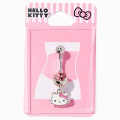 a hello kitty belly ring with a pink bow on the front and white polka dots on the back