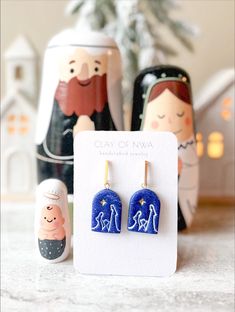 Nativity Scene Polymer Clay Handmade Earrings available now! Earring posts and hooks are purchased externally, but are 304 grade stainless steel which is considered hypoallergenic. Earrings are approximately 1.75 inches tall.  All orders are handmade and made to order. Because every earring is handmade with love and no two are perfectly alike. While I do my best to ensure every pair looks like the ones pictured, there may be slight variations in color shade and shape from the listing pictures *Care Instructions Below* Store earrings in a clean dry area. Do not wear in water. While Polymer Clay earrings can bend and flex slightly, it is important to be gentle when handling. Avoid dropping earrings onto hard surfaces to prevent breaking, cracking, or bending. When storing/traveling with Poly Handmade Drop Earrings For Holiday, Handmade Christmas Drop Earrings, Adjustable Earrings As A Christmas Gift, Adjustable Earrings For Christmas Gift, Blue Earrings For Christmas Gift, Christian Clay Earrings, Nativity Polymer Clay Earrings, Nativity Clay Ornaments, Clay Cross Earrings