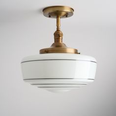 a white light fixture hanging from the ceiling