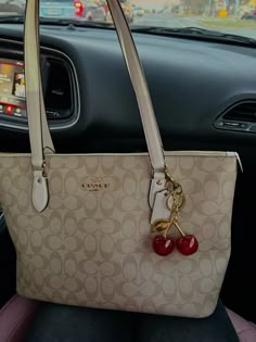 Coach bag, white coach tote, purses, coach purse, neverfull, cherry charm Coach Tote Bags Aesthetic, Coach Bag Charm Ideas, Coach Tote Bag Aesthetic, Coach Small City Tote, Coach City Tote Bag, Coach Bags Tote, Coach Cherry Charm, Coach Bah, Coach Bag Charm