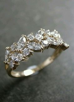 a gold ring with white diamonds on it