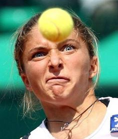 a woman with a tennis ball on her head