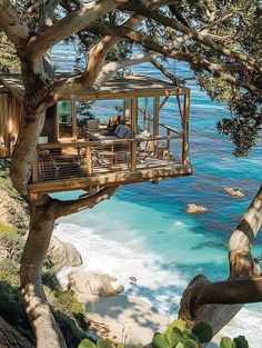 a tree house sitting on top of a cliff next to the ocean