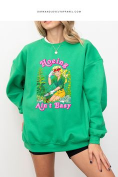 Upgrade your gardening wardrobe with the hottest sweatshirt trend: Hoeing ain't easy! Our barbiecore crewneck is equal parts cute and functional, combining a girly aesthetic with a powerful graphic that shows your hilarious gardening struggles. Don't be caught without this must-have gardening accessory! Girly Aesthetic