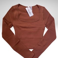 Amazing Seamless Top With Long Sleeves Super Soft And Stretchable Giving You A Figure Hugging Look Available S/M And M/L Seamless Scoop Neck Top For Fall, Casual Brown Top With Seamless Construction, Fall Scoop Neck Top, Solid Seamless Tops For Fall, Fall Seamless Scoop Neck Top, Fitted Brown Tops With Seamless Collar, Brown Stretch Sports Tops, Seamless Design Crop Top, Sporty Brown Stretch Top