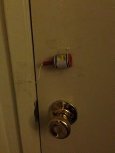 an open door with a toothbrush hanging on it's side and a tube of toothpaste stuck to the handle