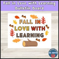 the fall in love with learning bulletin board is displayed on a wooden surface, and it has