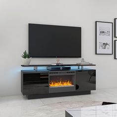 an entertainment center with a fireplace in the middle and pictures on the wall behind it