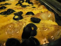 a casserole dish with olives and cheese