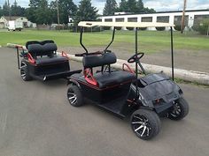 two black and red golf carts parked on the street