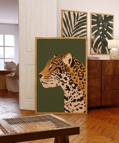 there is a leopard on the wall in this living room with wood flooring and paintings