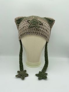 a knitted hat on top of a mannequin's head with two crocheted ears