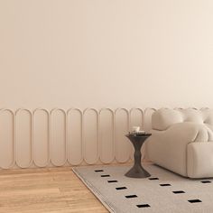 a white couch sitting on top of a wooden floor next to a radiator