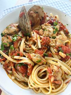 a white bowl filled with pasta and sauce