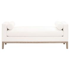 a white couch with two round arms and legs on the back, in front of a white background