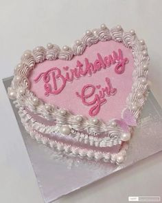 a heart shaped birthday cake with the words birthday girl written on it in pink and white frosting