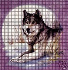 a cross stitch wolf laying down in the snow