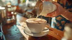 a person pouring coffee into a cup