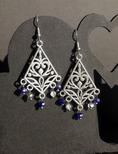 ♥ 10% off when you buy two pairs of earrings. Use code 10OFFTWO at checkout. ♥ Stunning Silver Navy Blue Filigree Earrings, Dark Blue Statement Earrings, Blue and Silver Chandelier Earrings, Blue Boho Hippie Fashion Earrings.  Silver plated ear hooks with silver toned pendant with swirl design.  Please see photos for details. Also available as ear studs or clip on.  The length of the earring is 4 cm (40 mm / 1.5 inches) from the base of the earring hook, and 2.5 cm (25 mm / 1 inch) in width.  Th Blue Chandelier Earrings For Party, Blue Sterling Silver Chandelier Earrings As Gift, Blue Metal Chandelier Earrings For Pierced Ears, Blue Teardrop Chandelier Earrings For Pierced Ears, Blue Dangle Teardrop Earrings, Elegant Blue Metal Chandelier Earrings, Elegant Blue Pierced Chandelier Earrings, Elegant Handmade Blue Chandelier Earrings, Blue Sterling Silver Chandelier Earrings With Ear Wire