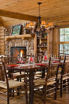 the dining room table is set with place settings for eight people, and there's a fireplace in the background