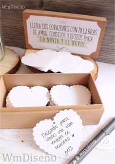 some white heart shaped cookies in a box with writing on the front and back side