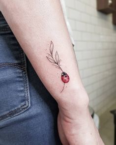 a ladybug tattoo on the left arm