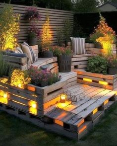 a wooden pallet filled with lots of plants and lit up lights on top of it